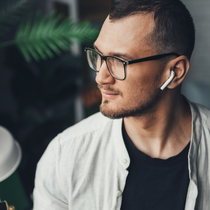 person looking away from camera with earphones in